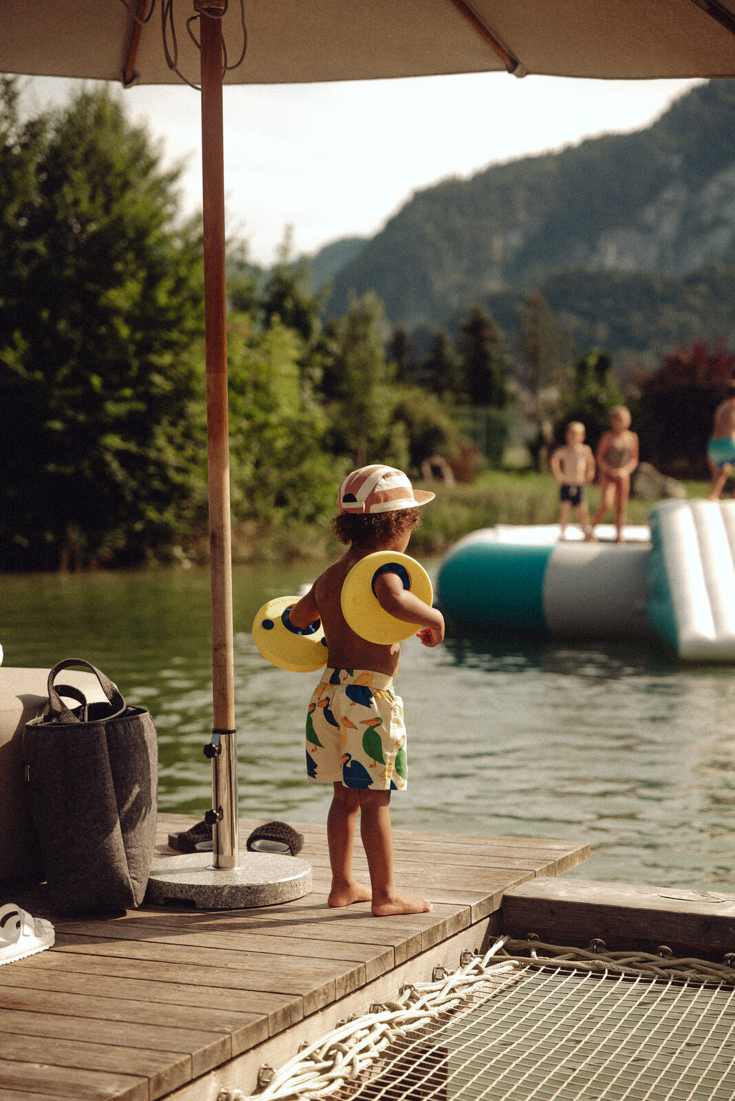 Children floating off the dock at golden hour.