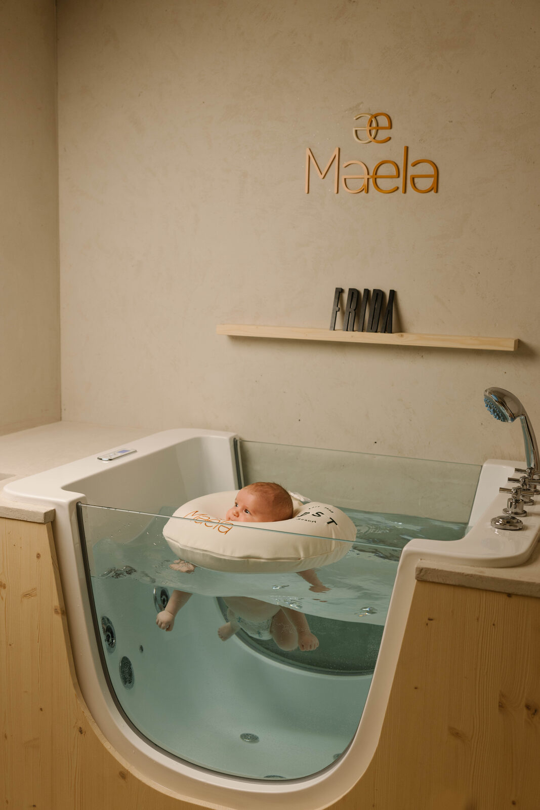 A baby floats in the Maela Baby Spa pod at POST.